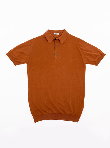 Flat lay of men's ginger/burnt orange short sleeve polo knit in a luxury and premium 100% merino wool.
